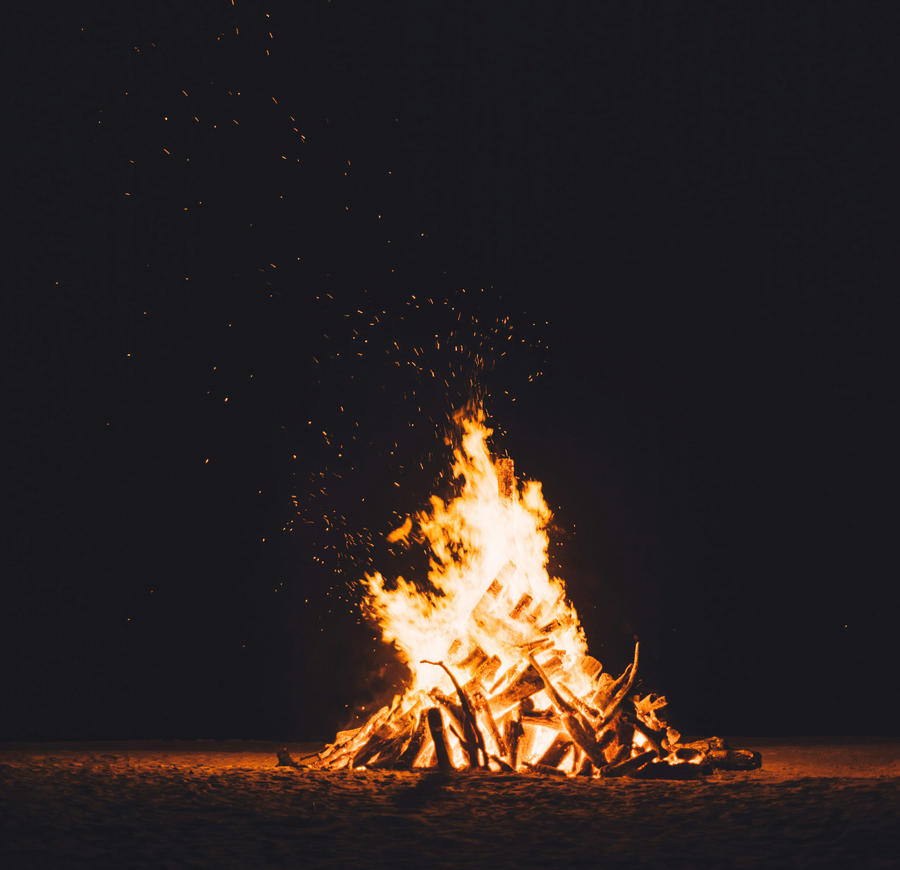 A burning bonfire against a dark black background