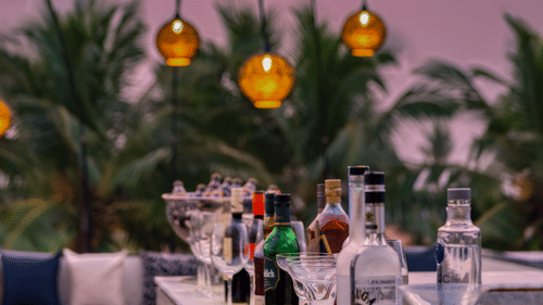 Liquor bottles placed in a line at a bar counter at our Benaulim Beach resort