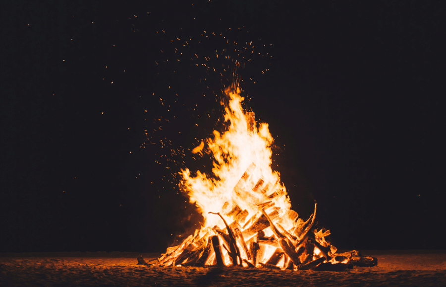 A burning bonfire against a dark black background