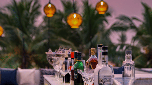 The outdoor dining area at the Lynx Restaurant, one of the best beach restaurants in South Goa, overlooking the pink-hued skies in the background.