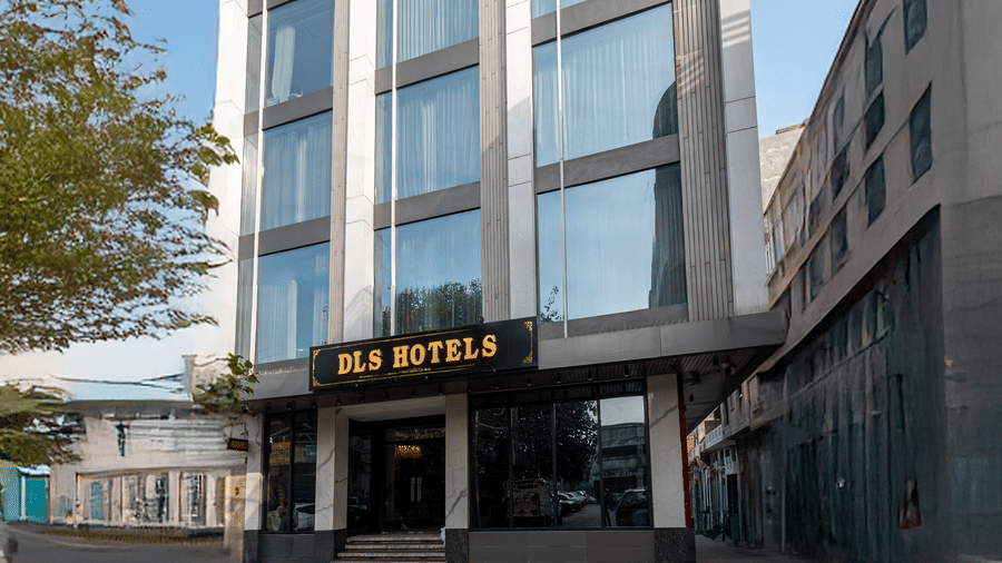 A multi storey hotel building with entrance and windows visible from street level at DLS Hotels Amritsar.