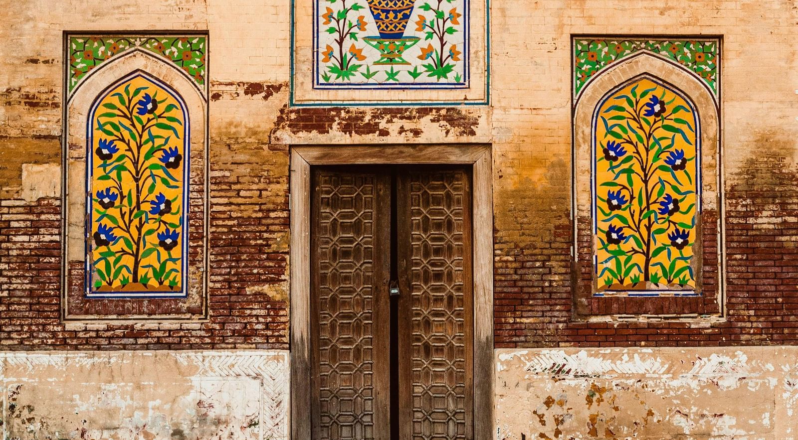 Ornate facade with colourful stained-glass windows and intricate detailing at a fort.
