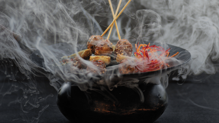 Smoke wafting off a black bbq sizzler pot at one of our Benaulim beach restaurants in South Goa