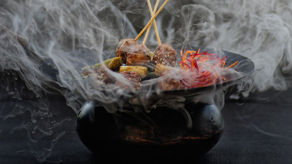 Smoke wafting off a black bbq sizzler pot at one of our Benaulim beach restaurants in South Goa