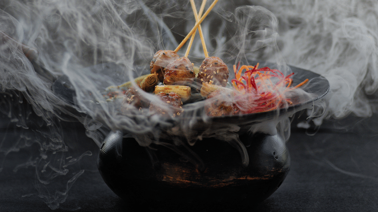 Smoke wafting off a black bbq sizzler pot at one of our Benaulim beach restaurants in South Goa