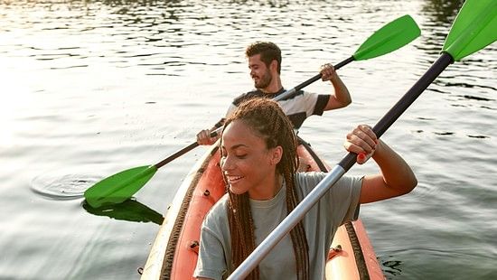 a man and a woman kayaking on a river