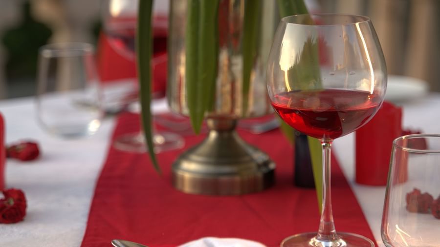 A sophisticated dinner setup with white flowers, candles, and fine-dining essentials - Kaldan Samudhra Palace