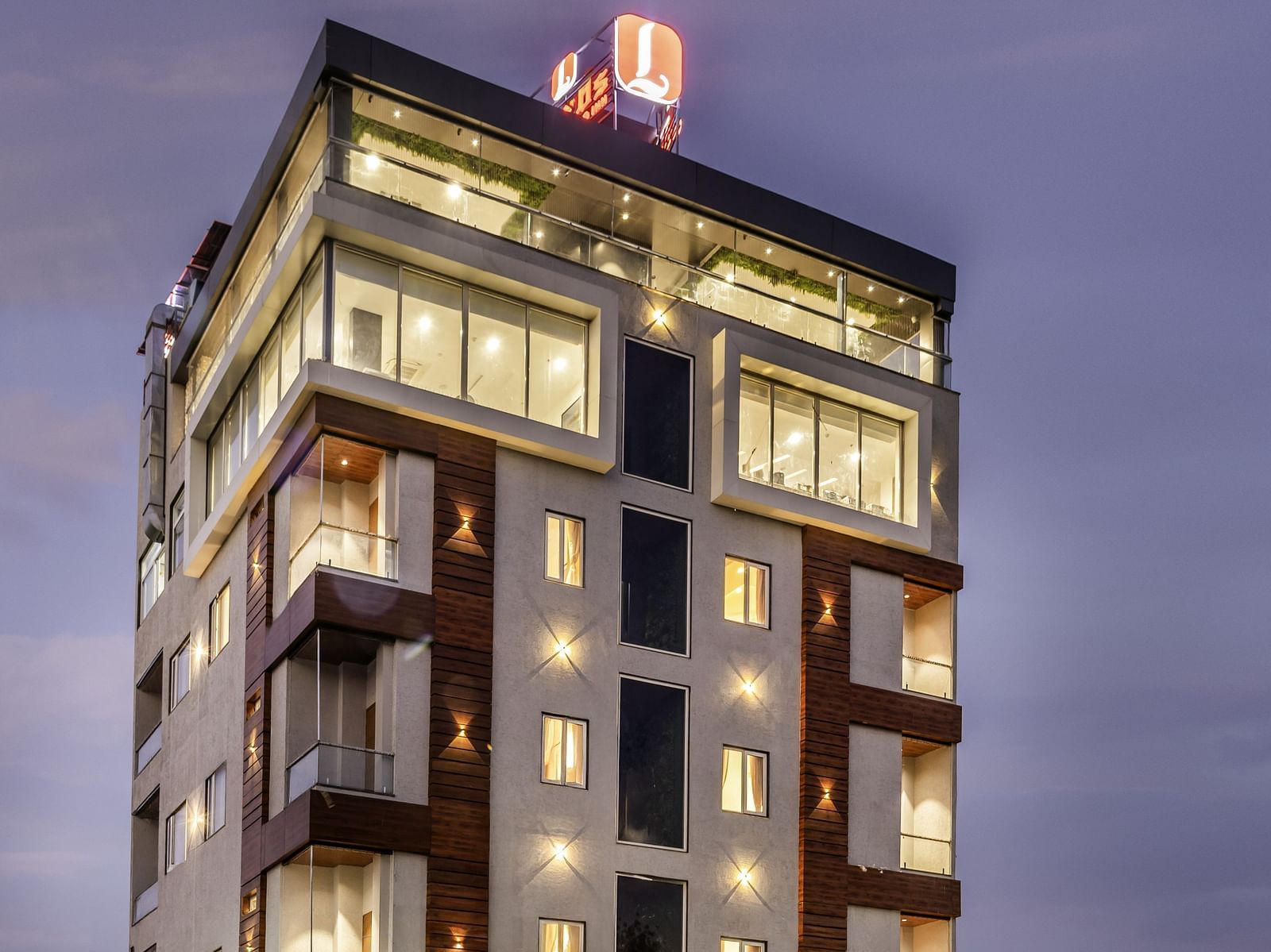 Lords Hotels & Resorts, best hotel in Sumerpur, Rajasthan, lit up at dusk, standing tall with modern architecture and a welcoming area near the road
