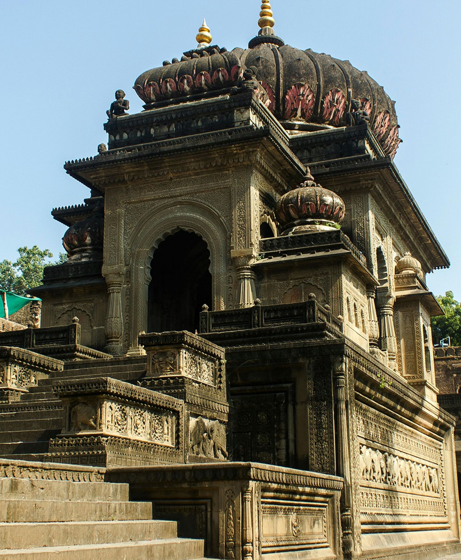 A historic intricately carved temple with detailed architecture under a clear sky