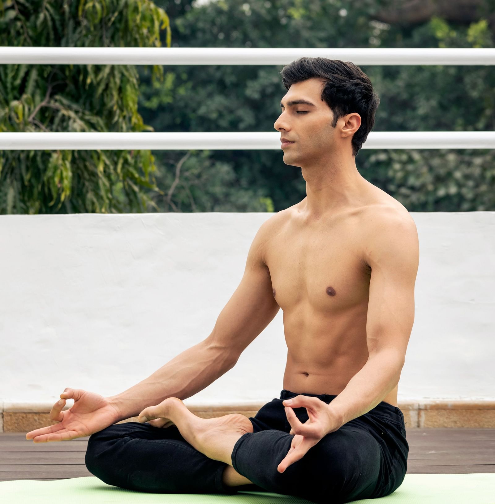 image of a man doing yoga on a yoga mat at The Claridges New Delhi