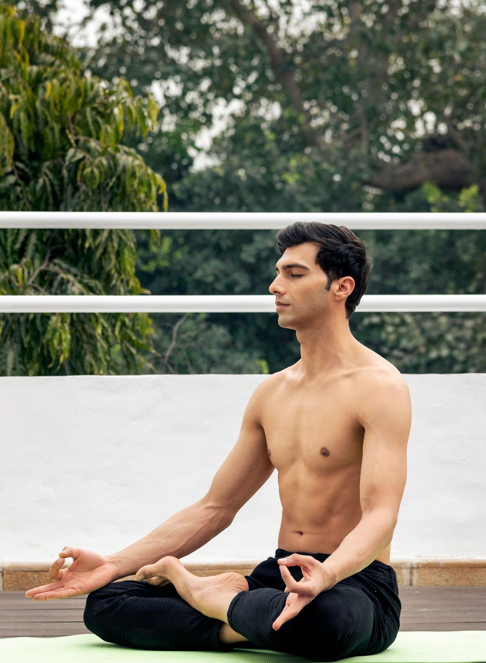 image of a man doing yoga on a yoga mat at The Claridges New Delhi
