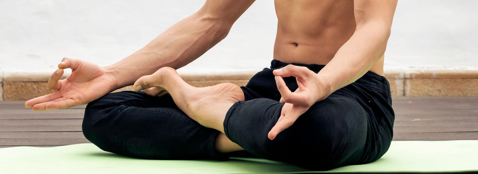 image of a man doing yoga on a yoga mat at The Claridges New Delhi