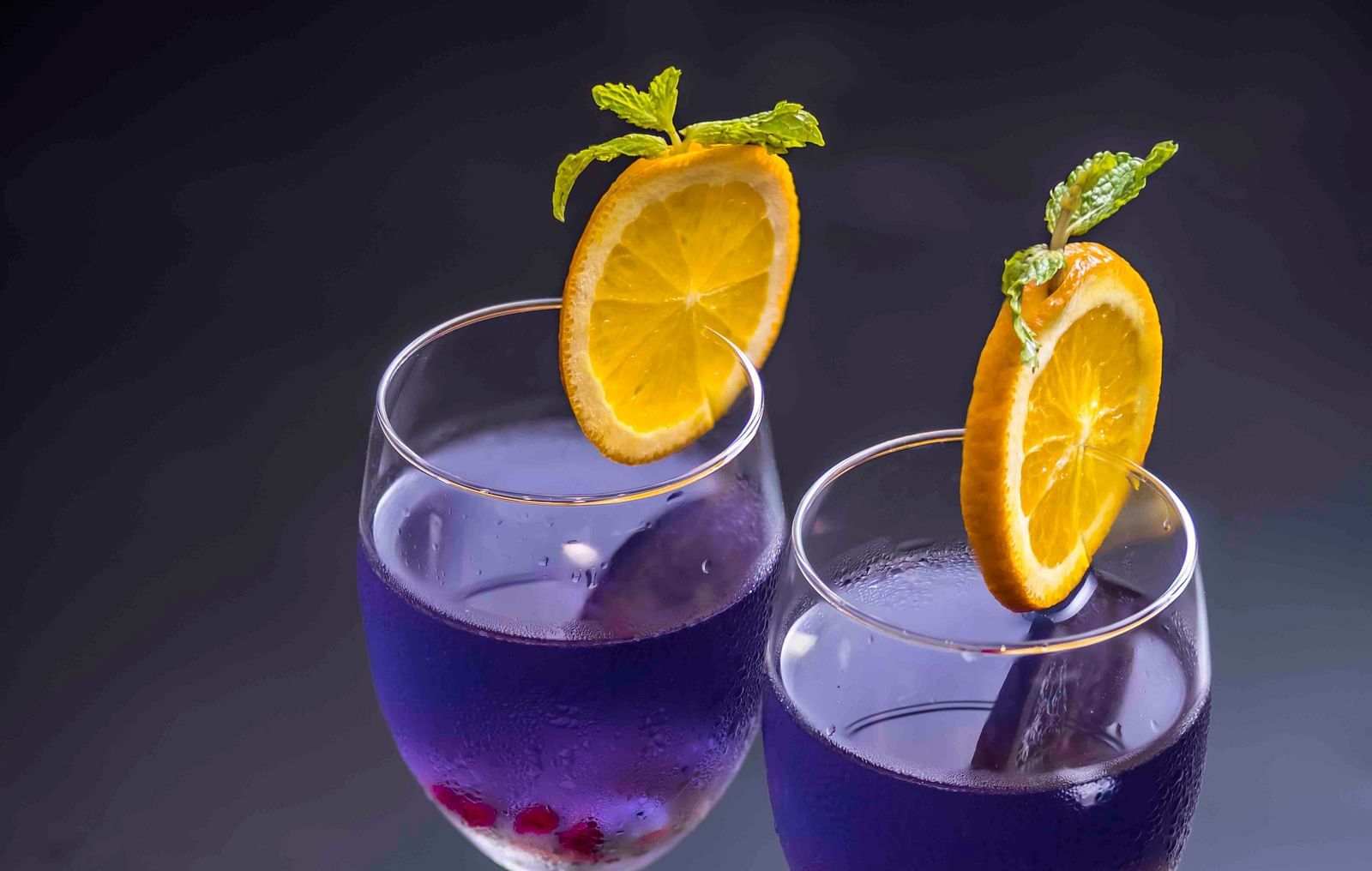 Image of butterfly pea flower tea in wine glass.