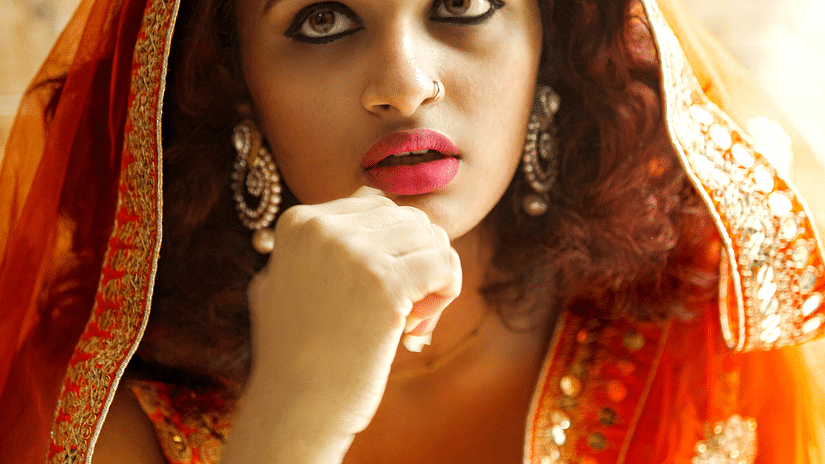 A bride dressed up in orange clothes - Hablis Hotel, Chennai