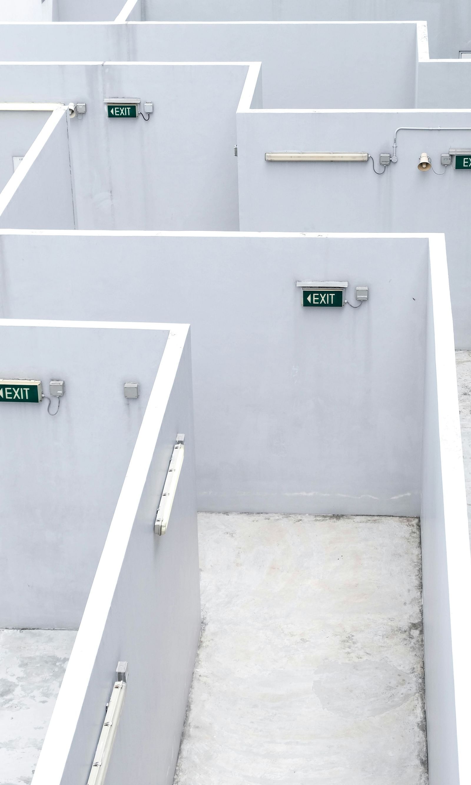 The top view of the maze shows white walls with exit signs clearly marked