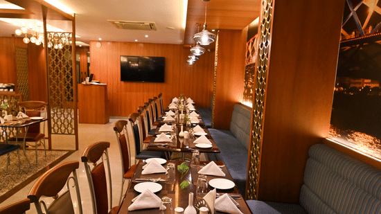 Private dining room at Rivera Sarovar Portico, Ahmedabad featuring neatly arranged tables, elegant lighting and a refined setting for intimate gatherings.