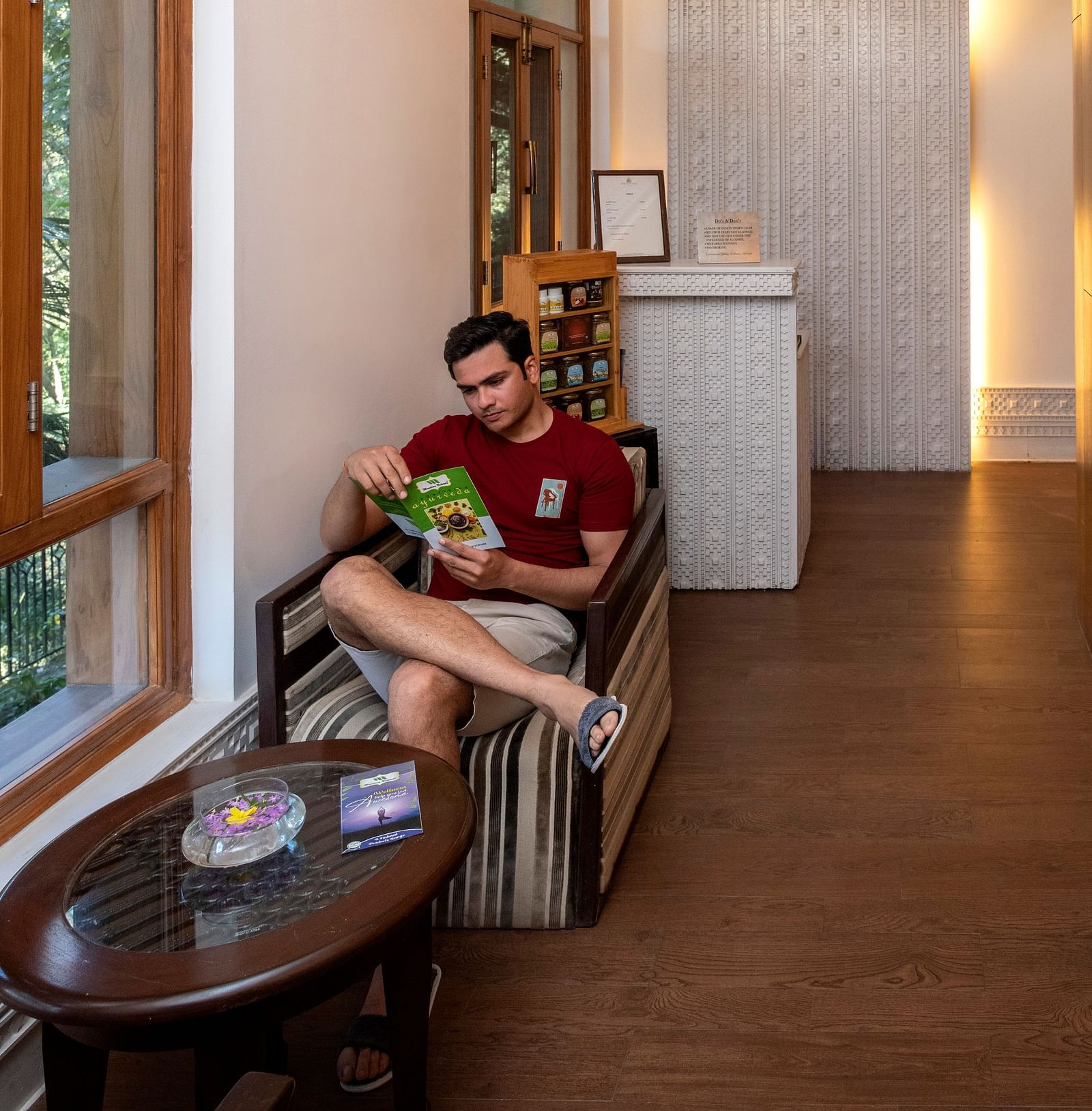 image of a man sitting in a corner and reading a book at our spa in Mussoorie