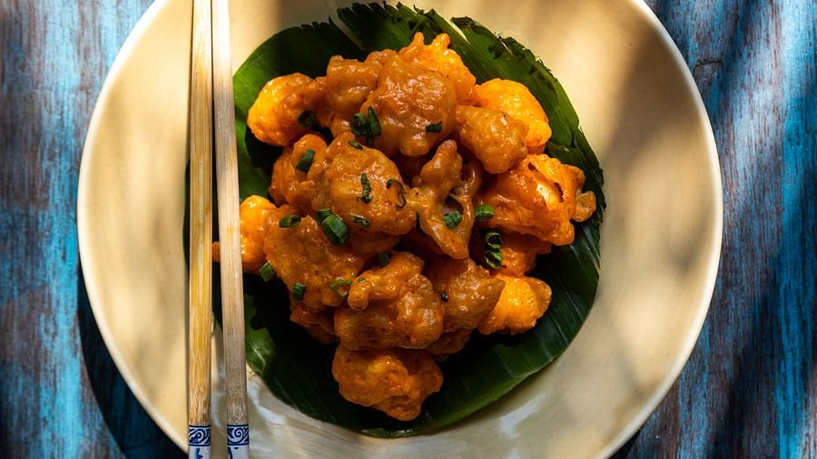 a plate of fried chicken and chopsticks