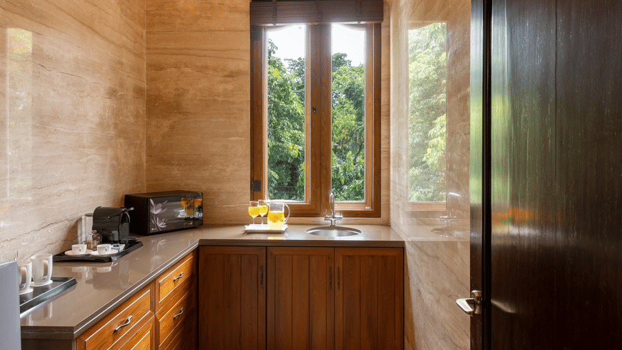 Premier Club Suite bathroom featuring marble finishes and a window view at Kenilworth Hotel, Kolkata.