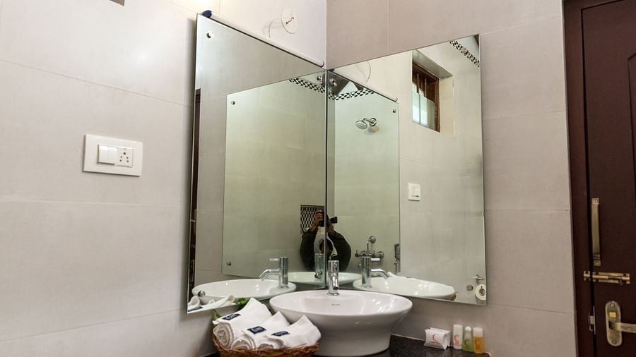Mirror above the sink at one of the rooms - Capitol Village Resort, Madikeri