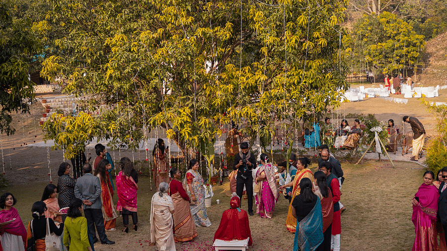 An aerial view of a wedding setup with people in the lawn at The Sylvan Retreat, Dehradun.