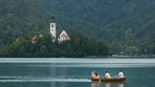 image of a serene lake where people are sailing in a boat