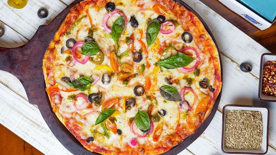 Top view of a pizza served at Ezr and Bar with branded packaging.