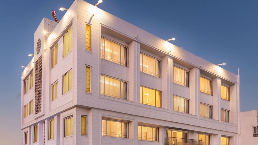 The illuminated facade of Dwarkadhish Lords Eco Inn at dusk.