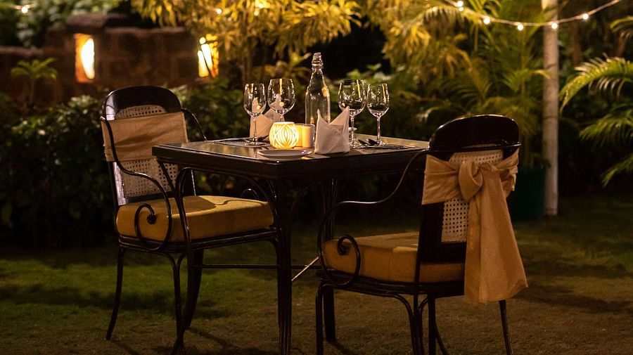 a romantic dinner setup with lights and candles
