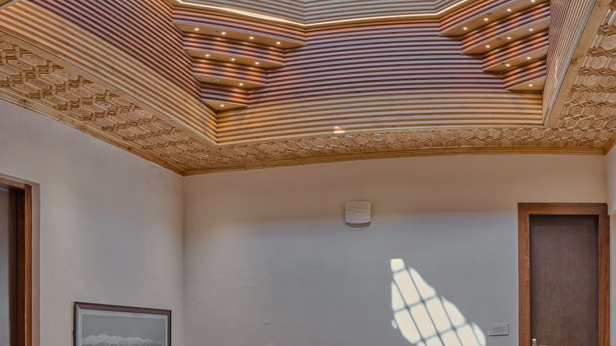 Intricate ceiling design above a grand staircase at Royal Comfort Regency, adding elegance to every arrival and departure.