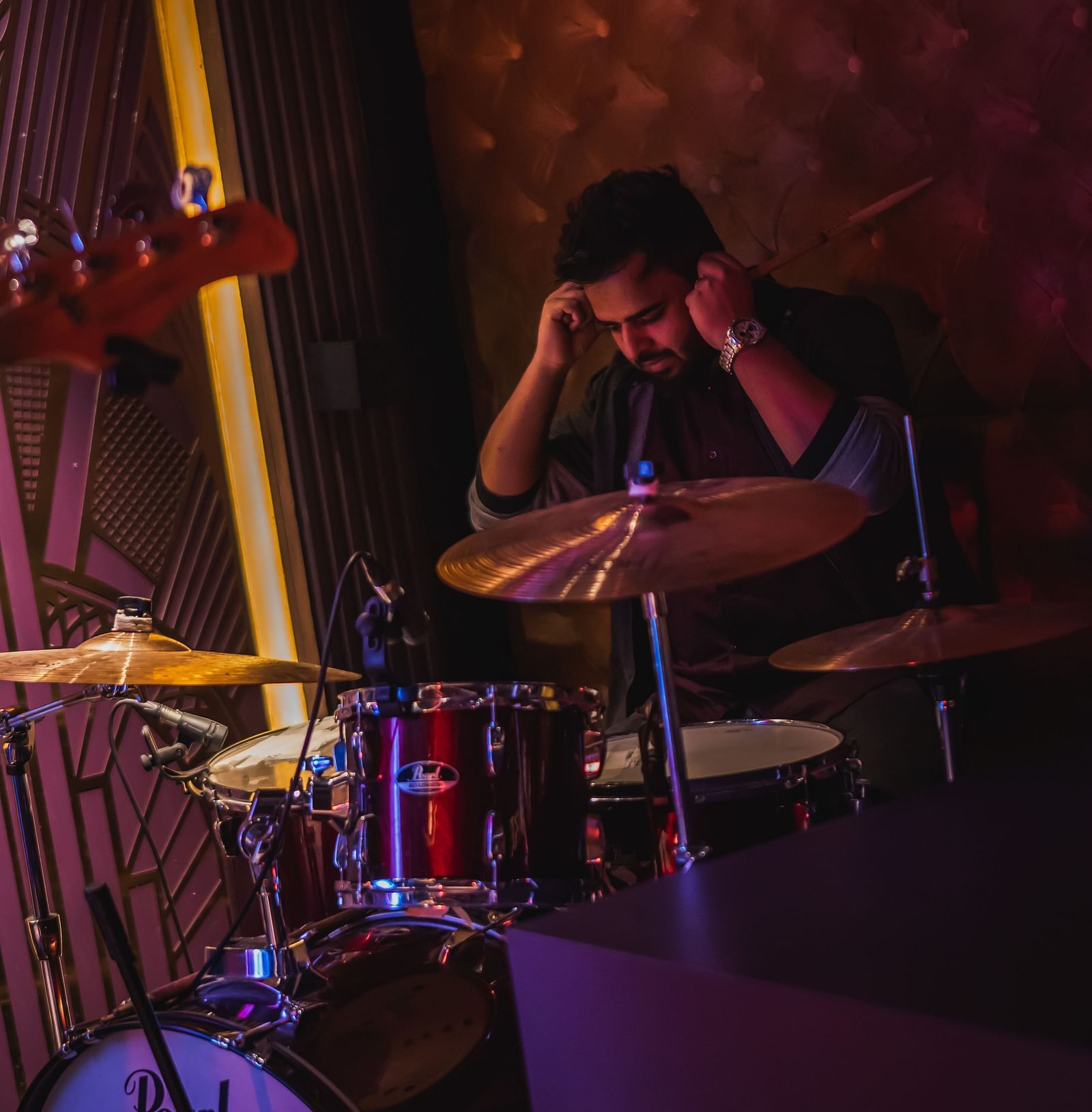 image of a an sitting behind a set of drums at The Claridges New Delhi