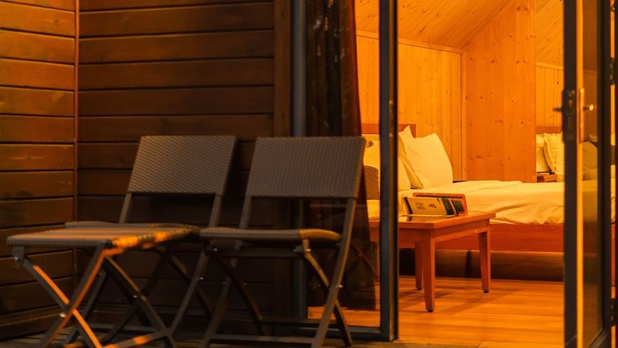 Evening view of the Cottage Room at Crescent Spa & Resort, Indore, featuring warm lighting that creates a decorative and inviting ambiance