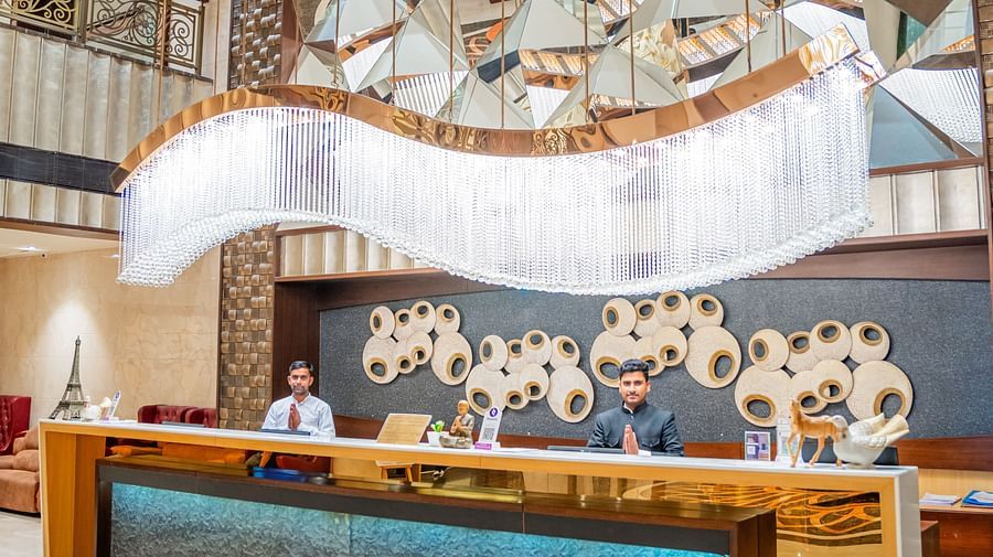 Welcoming Reception with Friendly Staff and Unique Lighting at Crescent Spa & Resort, Indore