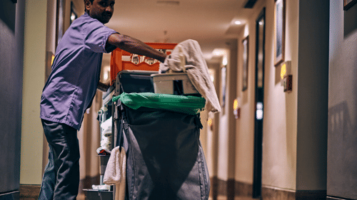 A janitor cleaning the hotel corridors