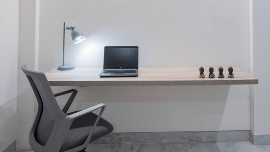 Corner workspace with table, lamp and desk setup at Nest by Rivido Apart Hotel, Bannerghatta Road