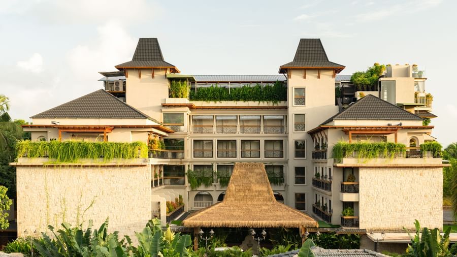 The exterior of The Evren, Vagator illuminated with sun rays with a bright blue sky in the background.