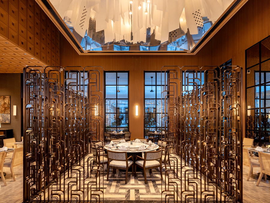 Front view of CHINCHIN restaurant at The Residency Signature Madurai with decorative metal partitions, pendant lighting, and warm ambient lighting.
