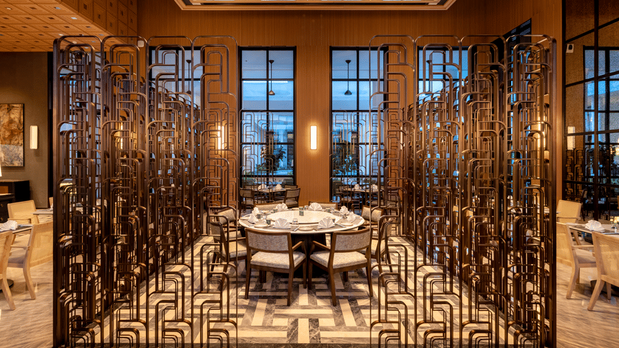 Front view of CHINCHIN restaurant at The Residency Signature Madurai with decorative metal partitions, pendant lighting, and warm ambient lighting.