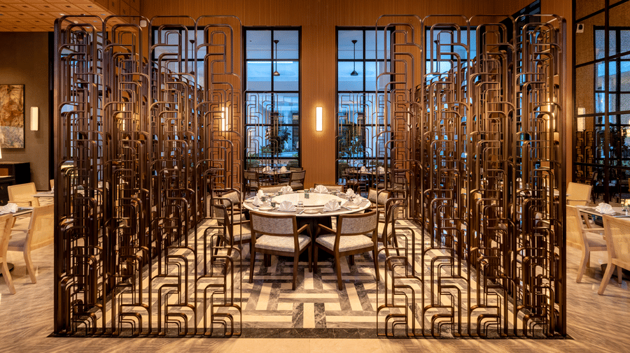 Front view of CHINCHIN restaurant at The Residency Signature Madurai with decorative metal partitions, pendant lighting, and warm ambient lighting.