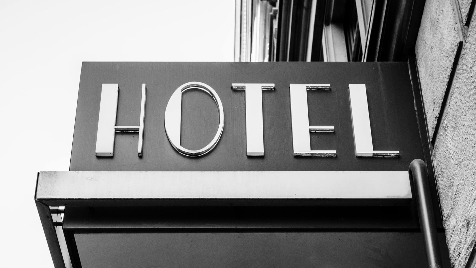 A classic hotel signboard marking the entrance to the property.