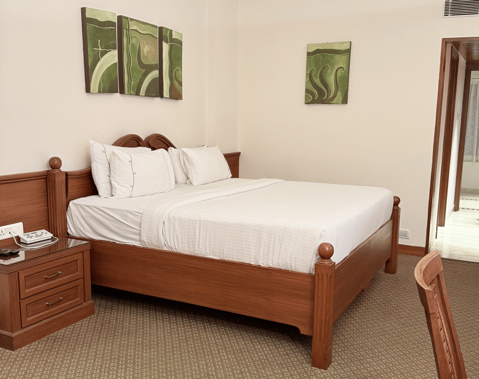A side view of a large bed with photo frames above the headboard | Cenneys Gateway