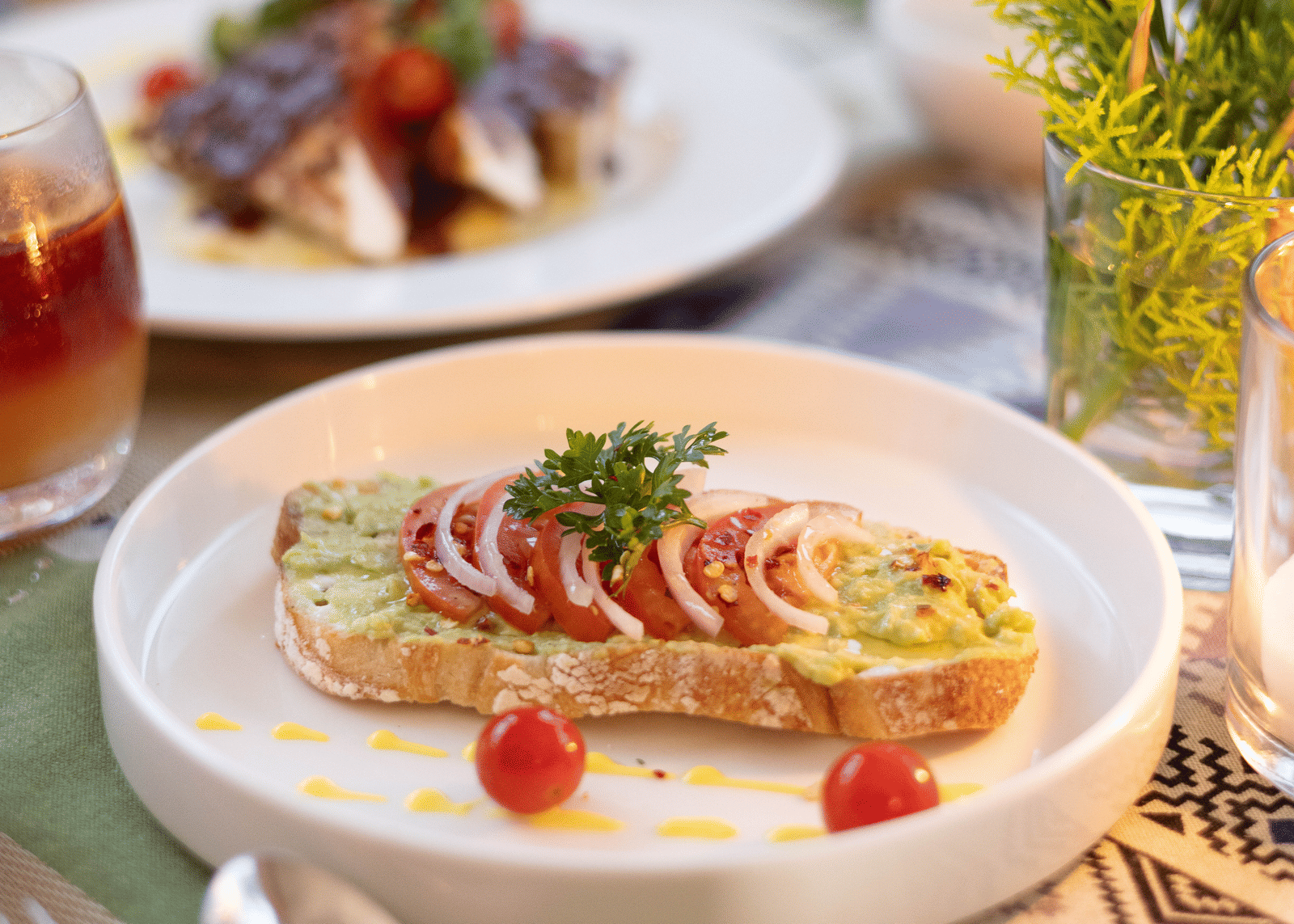 A close-up shot of an appetiser or dessert, featuring fruit and a creamy topping, on a white plate - Megha Resort & Villas, Dehradun