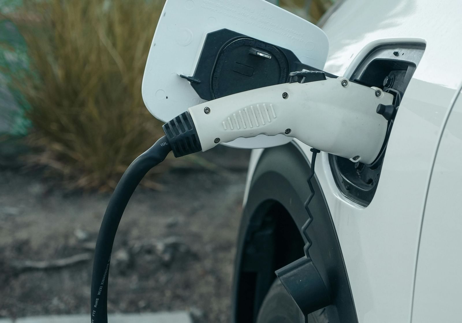 A car connected to an EV charger.