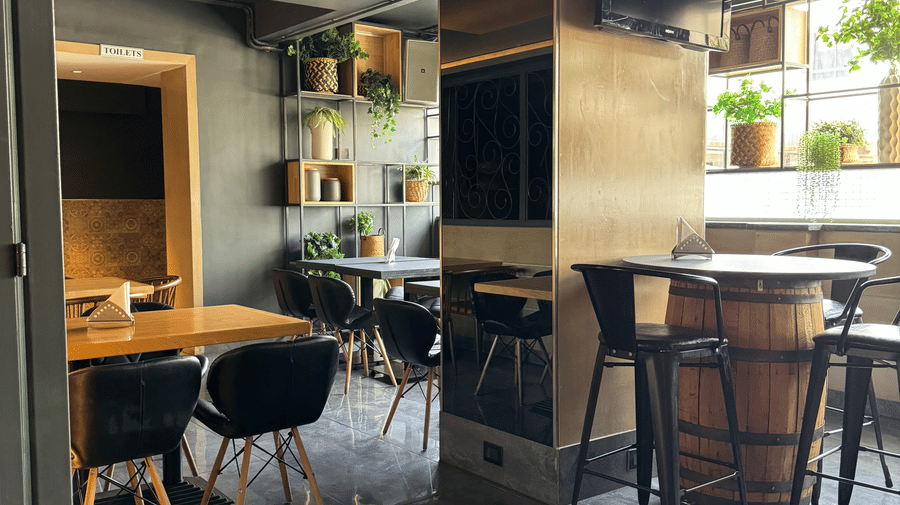 A cosy dining area with tables and chairs, showing a relaxed atmosphere at Cenneys Gateway - Pride of Salem.