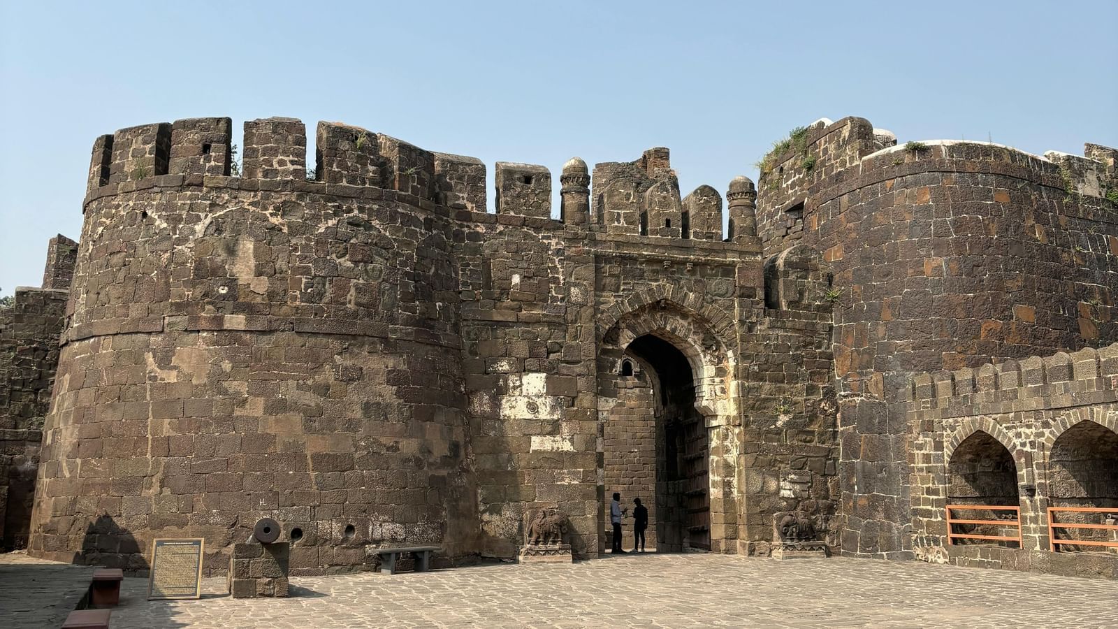 Old stone fort with high walls and arched gateways standing strong against the sky.