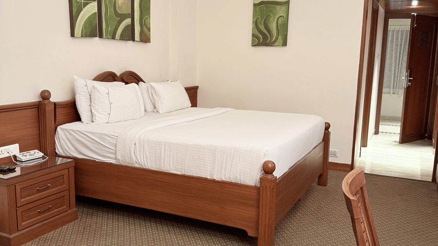 A side view of a large bed with photo frames above the headboard | Cenneys Gateway