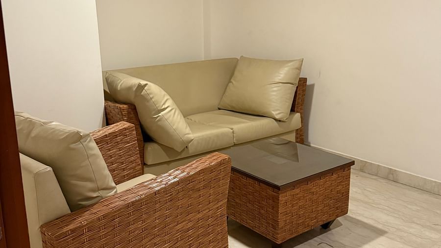 A spacious room with cushioned sofas and a table | Cenneys Gateway