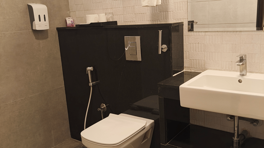 Modern bathroom in the Suite Room at De Venetian by TGI featuring premium fixtures and a sleek design.