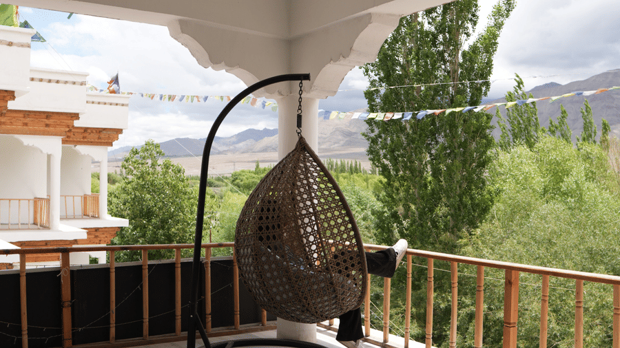A space with a hanging swing, plants, and sky in the backdrop | Indus Serinity, Leh Ladakh