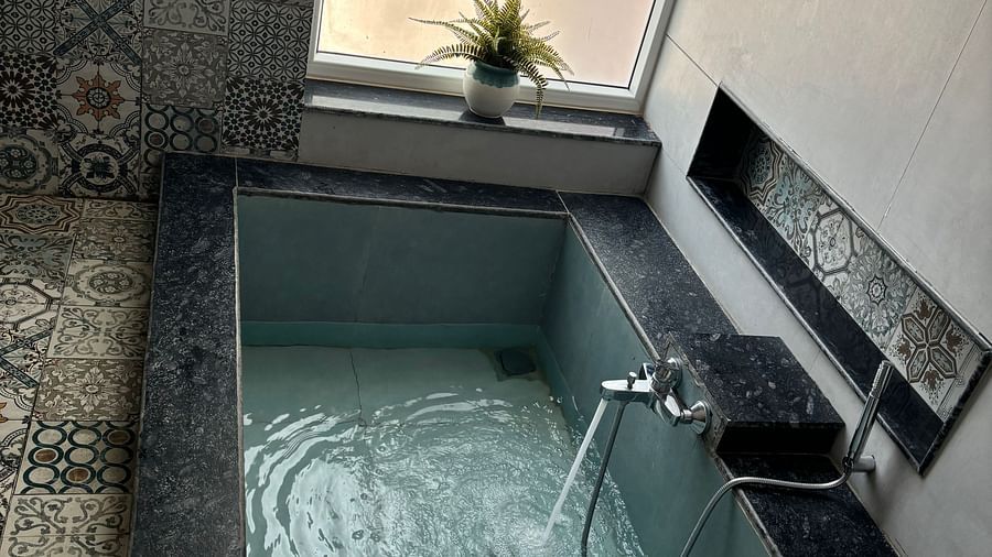 Indoor jacuzzi setup in a tiled bathroom at Tisya Farms, Gurgaon.